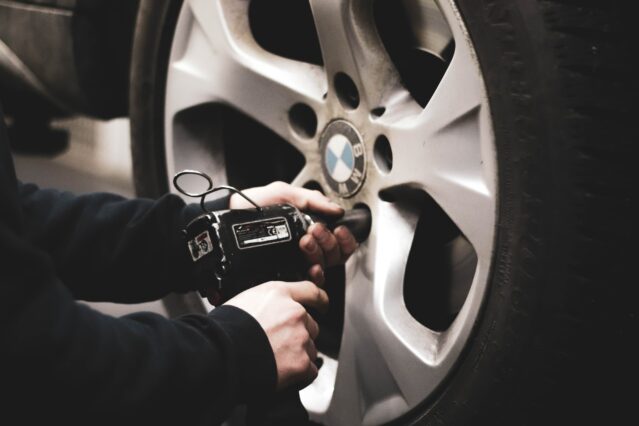 mechanic changing BMW car tyre