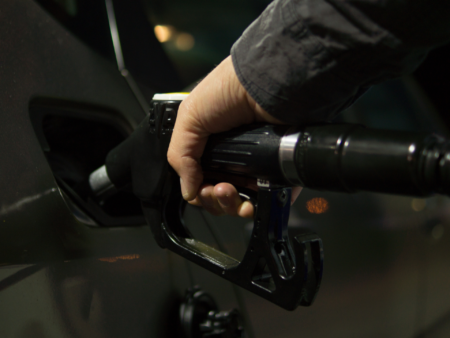 person filling up car with fuel